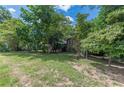 Two-story home with brick chimney surrounded by lush trees on a large lawn at 1737 Fontaine Dr, Jonesboro, GA 30236
