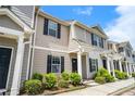 Exterior view of multi-unit townhomes featuring tidy front landscaping and dedicated entrances at 4043 Avalon Sw Rd, Atlanta, GA 30331