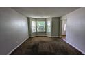 Cozy living room with a large bay window allowing natural light and plush carpeting for a comfortable atmosphere at 3679 Waldrop Cliff Ln, Decatur, GA 30034