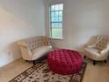 Cozy bonus room with neutral walls, plush seating, a patterned rug, and natural light from the window at 4037 Hill Station Ct, Sugar Hill, GA 30518
