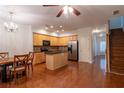 Open concept kitchen with stainless steel appliances, island and adjacent dining area at 2986 Ashlyn Pointe Dr, Atlanta, GA 30340