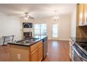 Bright open kitchen featuring an island with sink, a view to the living area, and stainless steel appliances at 2986 Ashlyn Pointe Dr, Atlanta, GA 30340