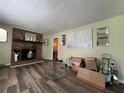 Spacious living room featuring a cozy brick fireplace and attractive hardwood floors at 2275 Chestnut Log Loop, Lithia Springs, GA 30122