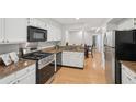 Well-lit kitchen featuring stainless steel appliances, granite countertops, and bright white cabinets at 3961 Riverlook Se Pkwy # 209, Marietta, GA 30067
