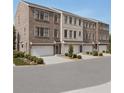 Exterior view of new construction townhomes showing brick facade, attached garages, and landscaped surroundings at 2197 Wexford Dr # 39, Atlanta, GA 30319