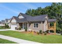 Beautifully landscaped house with an attached two-car garage and a cozy side porch overlooking the lake at 301 Retreat Way, Carrollton, GA 30116