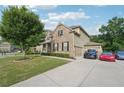 Lovely home shows a three-car garage, long driveway, and well-kept lawn at 6415 Yellow Birch St, Cumming, GA 30040