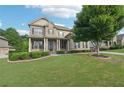 Charming home with a green lawn and manicured bushes lining the front porch at 6415 Yellow Birch St, Cumming, GA 30040