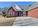 Charming red brick home with an arched entryway and manicured garden at 337 Inverness Ave, Mcdonough, GA 30253