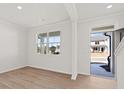 Bright and airy living room featuring clean white walls, wood-look flooring, and a large window at 2717 Montie Ct, Lithia Springs, GA 30122