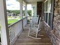 Inviting front porch with rocking chairs and stone accents, perfect for relaxing at 493 Kyles Cir, Hiram, GA 30141