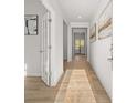 Bright hallway with natural light, wood floors, and elegant artwork for a warm, inviting feel at 112 Crooked Lake Park, Villa Rica, GA 30180