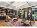 Elegant living room with a fireplace, bookshelves, and refined decor at 2442 Crescent Park Ct, Atlanta, GA 30339