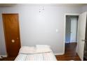 View of the bedroom with hardwood floors and neutral-toned walls, connecting to an adjacent room at 88 Greene Ne St, Fairburn, GA 30213