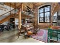 Open-concept living area with exposed brick, high ceilings, and a cozy seating area at 170 Boulevard Se # H-221, Atlanta, GA 30312
