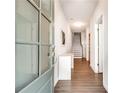 View of the entryway with wood floors and view of staircase in a modern design at 768 Aerial Way, Atlanta, GA 30312