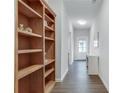 Hallway with white paint, wood floors and built-in bookshelf at 768 Aerial Way, Atlanta, GA 30312