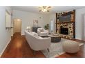 Comfortable living room with hardwood floors and a cozy stone fireplace at 2695 Trotters Walk Trl, Snellville, GA 30078
