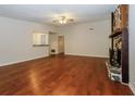Spacious living room with hardwood floors, a stone fireplace, and natural light at 2695 Trotters Walk Trl, Snellville, GA 30078