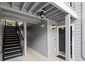 The exterior entrance to unit 620 with painted gray wood paneling and black trim at 620 Granville Ct, Sandy Springs, GA 30328