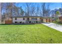 Beautifully landscaped one-story home featuring a well-manicured lawn, covered entryway, and a long driveway at 5109 Dogwood Hills Dr, Sugar Hill, GA 30518
