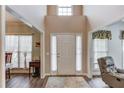 Bright entryway featuring wood-look flooring, neutral paint, and a view to the living room at 658 Eight Point Ct, Suwanee, GA 30024