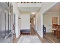 Inviting entryway with wood floors, a bench, and a view of the dining room at 658 Eight Point Ct, Suwanee, GA 30024