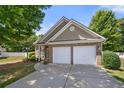 Charming brick home with a two-car garage and well-maintained landscaping and a manicured lawn at 2401 Centennial Hill Way, Acworth, GA 30102