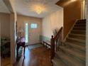 Inviting foyer with parquet floors, a decorative chandelier, and staircase leading to the upper level at 4402 Autumn Hill Drive, Stone Mountain, GA 30083