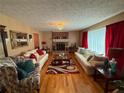 Spacious living room features hardwood floors, fireplace, and bright, neutral decor at 4402 Autumn Hill Drive, Stone Mountain, GA 30083