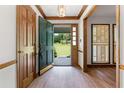 Light-filled entryway featuring an open door to the expansive front yard with beautiful hardwood floors at 41 Ridgewood Cir, Mcdonough, GA 30252
