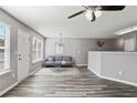 Spacious living room with hardwood floors, gray walls, and a ceiling fan at 5446 Waterfall Ct, Atlanta, GA 30349