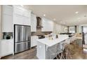 Bright kitchen featuring stainless appliances, an island with seating, and hardwood floors flowing into the living area at 4311 Parkside Pl, Atlanta, GA 30342