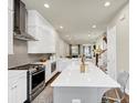 Modern kitchen with white cabinetry, stainless steel appliances, and a spacious gray island with seating at 4311 Parkside Pl, Atlanta, GA 30342