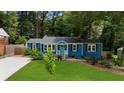 Charming blue home with black shutters and a neatly landscaped front yard at 1718 Cahoon Sw St, Atlanta, GA 30310