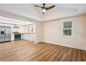 Living room with vaulted ceilings and hardwood flooring adjacent to the kitchen at 2155 S Deshon S Rd, Lithonia, GA 30058