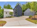 Contemporary home with a stylish two-car garage and modern architectural design at 160 Cedarwood Ln, Roswell, GA 30075