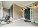 Inviting front porch with seating, perfect for enjoying the outdoors, and stylish front door at 207 Breckenridge Ct, Canton, GA 30115