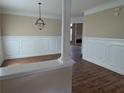 Spacious dining room with stylish lighting, wood flooring, and decorative trim at 735 Briarhurst Ct, Lawrenceville, GA 30046