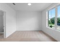 Bright, carpeted bedroom with a large window offering a scenic view and an adjacent bathroom at 4243 Millcroft Pl # 203, Buford, GA 30518