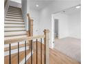 Bright entryway featuring hardwood floors, staircase with iron spindles, and an open doorway at 4243 Millcroft Pl # 203, Buford, GA 30518