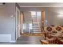 Cozy living room featuring gray walls, wood-look floors, a staircase and a floral patterned couch at 3301 Henderson Mill Rd # X4, Atlanta, GA 30341