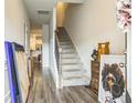 Inviting hallway with stairway and wood floors, leading to other rooms at 7240 Kings Cv # 11, Austell, GA 30168
