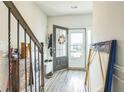 Bright foyer with a glass front door and hardwood flooring, adjacent to the stairs at 7240 Kings Cv # 11, Austell, GA 30168