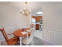 Cozy dining area features a classic chandelier and is adjacent to the kitchen, with natural light at 1800 Clairmont Lk # 326, Decatur, GA 30033