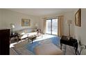 Inviting living room with a comfortable sofa and sliding door to a private balcony, filled with natural light at 1800 Clairmont Lk # 326, Decatur, GA 30033
