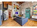 Bright living room with exposed brick, modern furniture, vibrant art, and a unique swing feature at 10 James St # 11B, Hampton, GA 30228