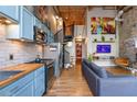 Spacious living area boasts exposed brick walls, modern decor, spiral staircase, and an open layout at 10 James St # 11B, Hampton, GA 30228
