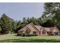 Attractive single-story brick home featuring manicured landscaping and a well-maintained lawn at 180 Jay Trl, Fayetteville, GA 30215