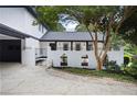 Attractive home featuring a white brick fence, black trim, and mature trees at 464 Rockborough Ter, Stone Mountain, GA 30083